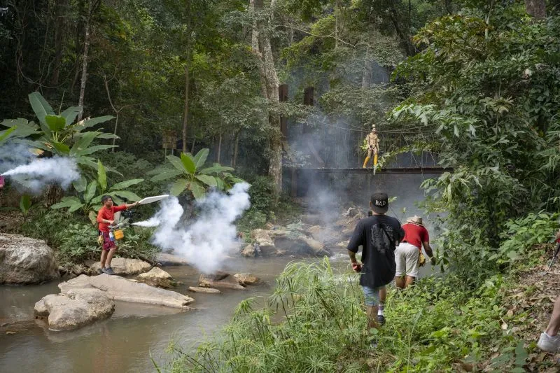 Film crew shooting at a jungle waterfall in Thailand